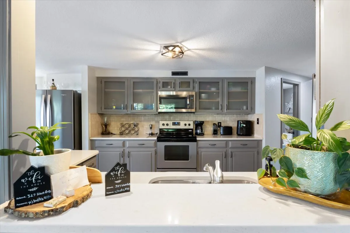 A view of a modern kitchen with high-end appliances, sleek cabinetry, and stylish countertop decor. The scene is clearly set up for active use, suggesting both practicality and visual appeal for gatherings and meal prep.